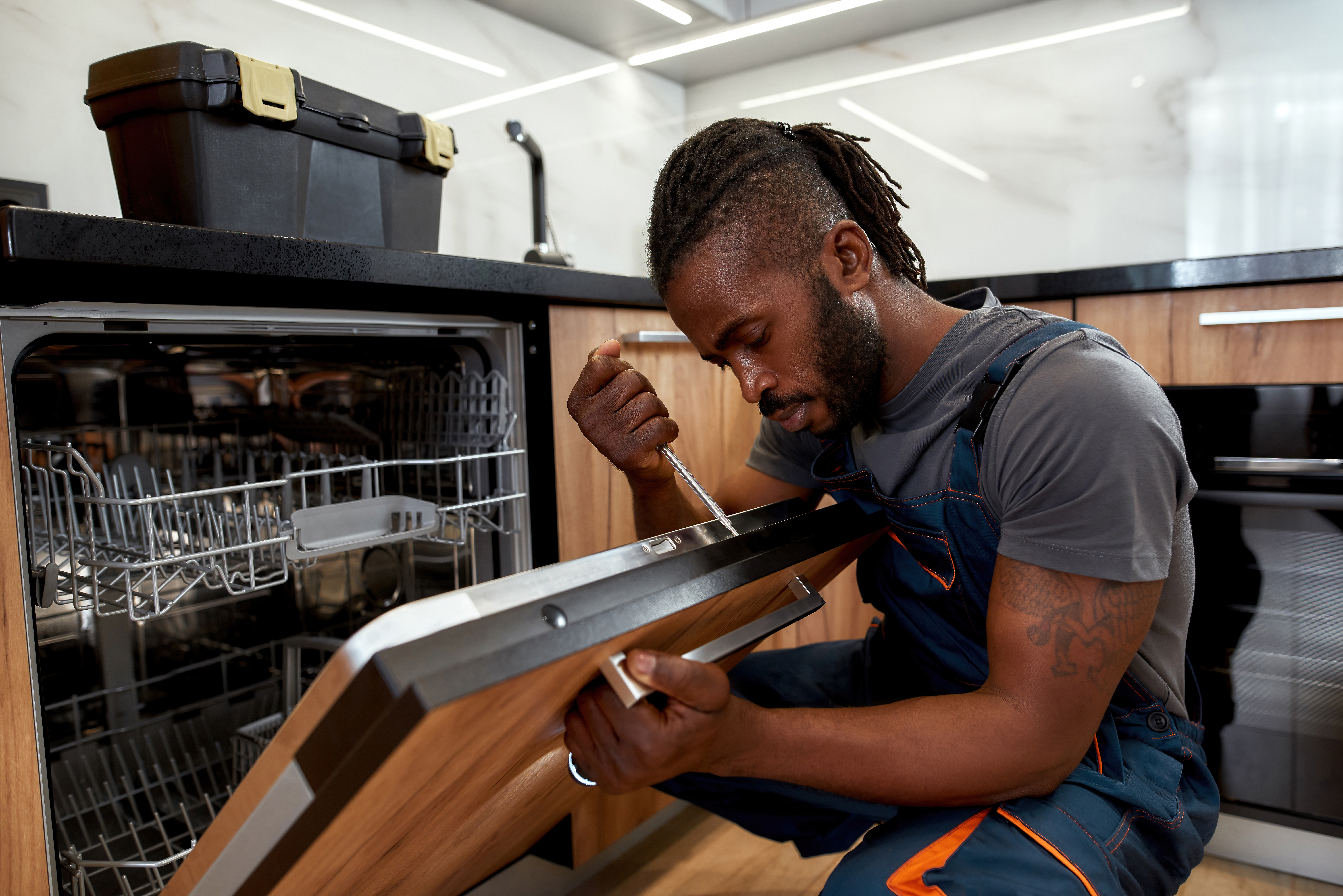 A WyattWorks service pro working on a diswasher installation in Cleveland, OH