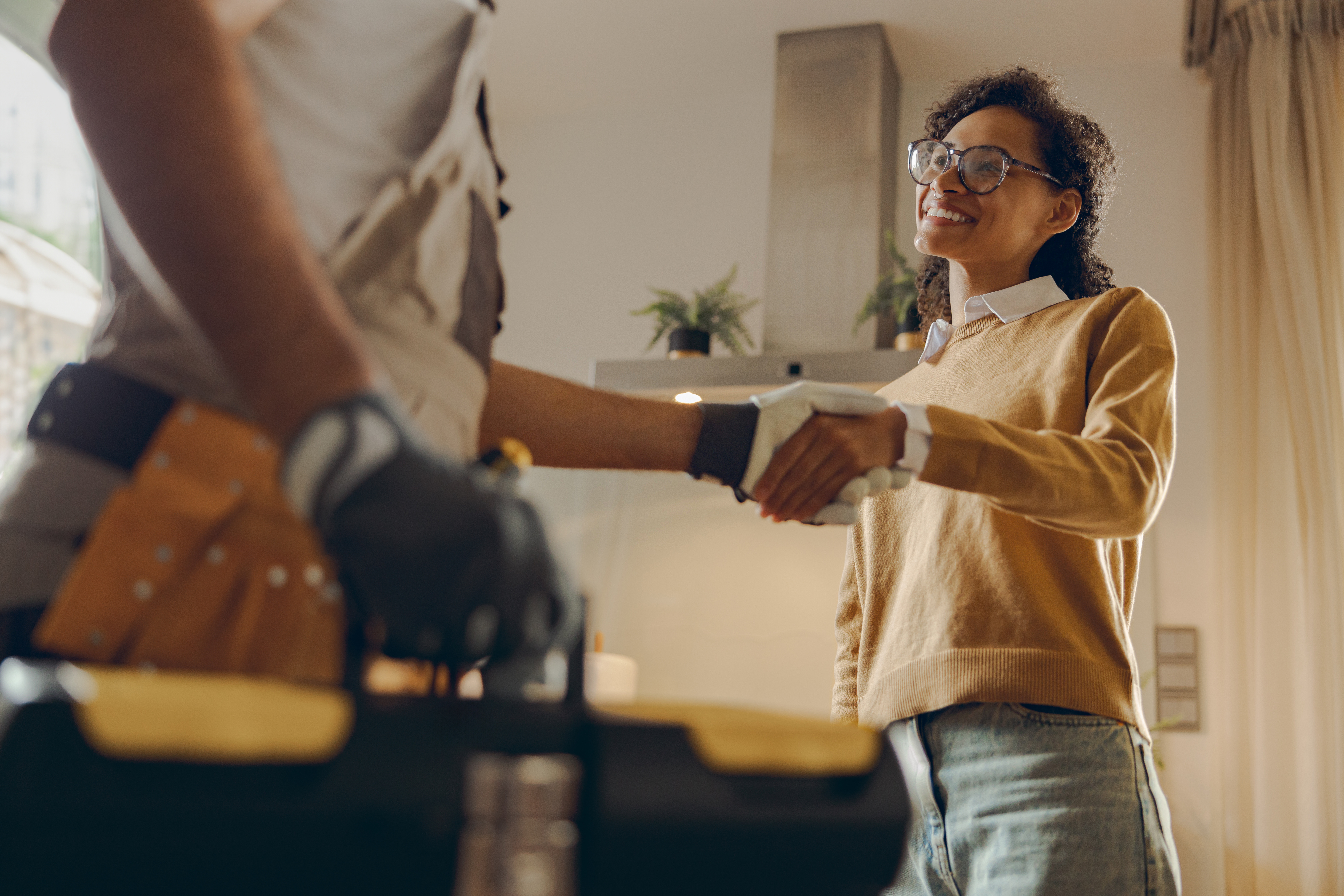 A plumber shaking hands with a happy client - WyattWorks is dedicated to customer satisfaction in Ohio & North Carolina.
