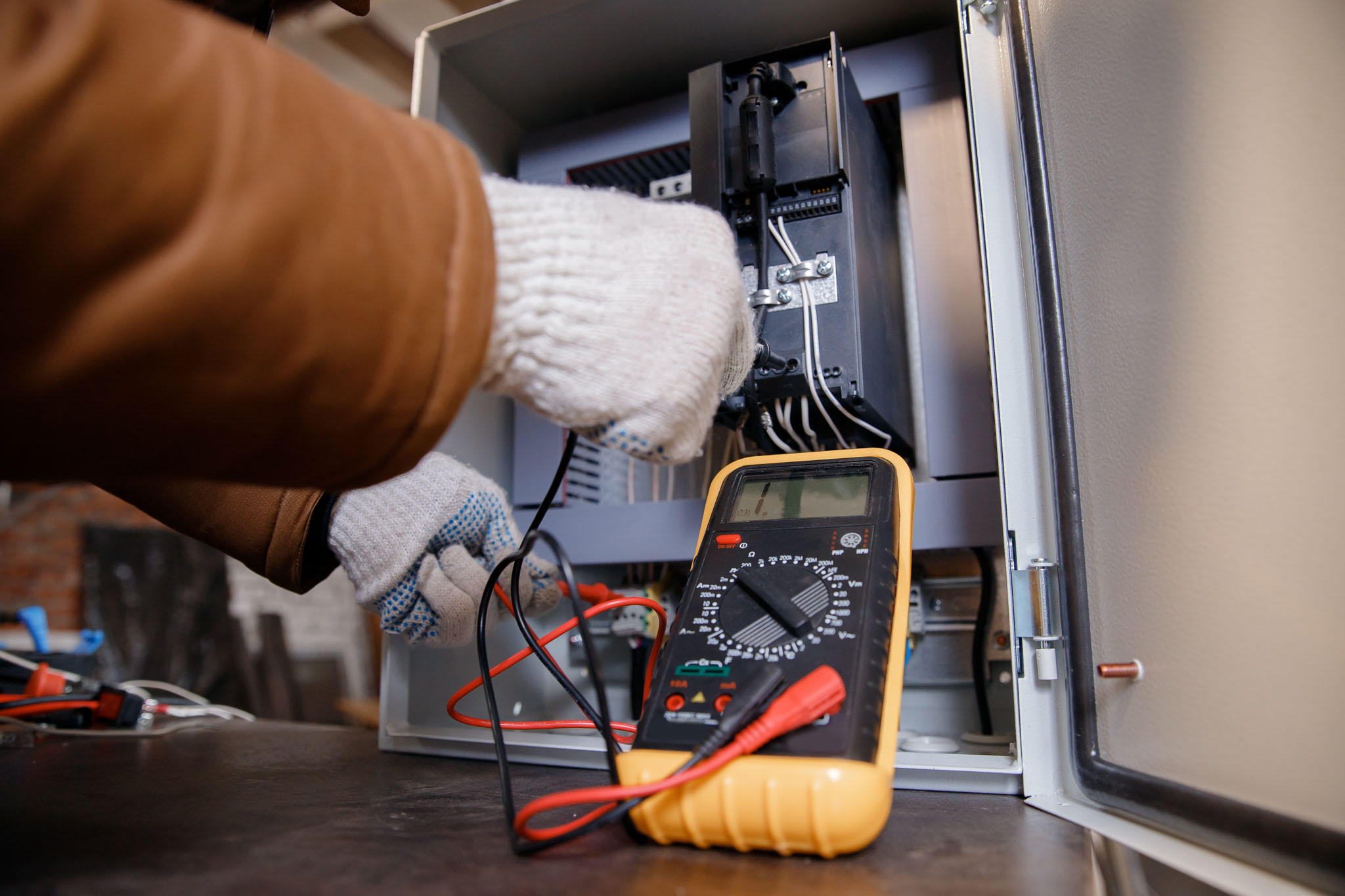 An electrician performing maintenance services for a home property.
