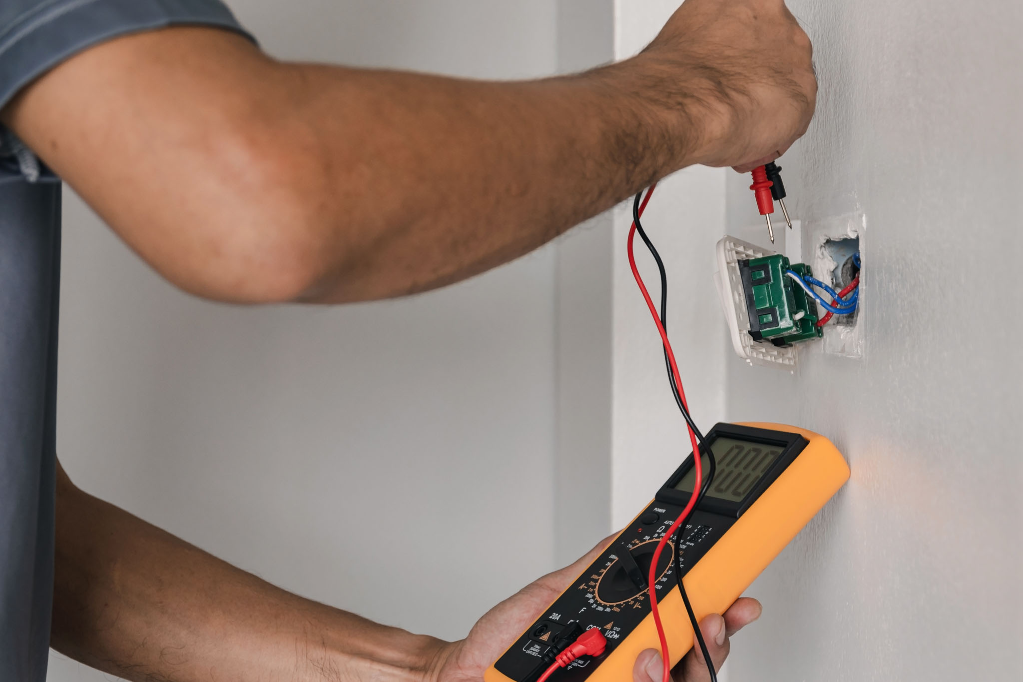 An outlet being inspected by an electrician - WyattWorks offers excellent electrical inspection in Cleveland, OH.